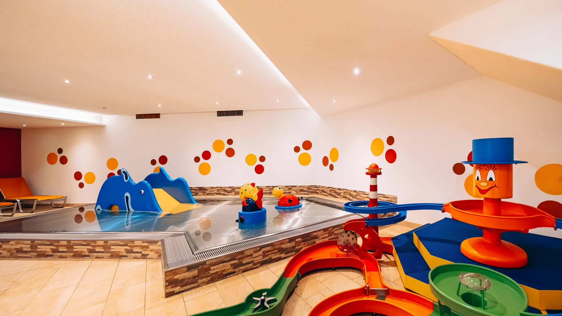 Colorful indoor kids' pool with slides and water play structures