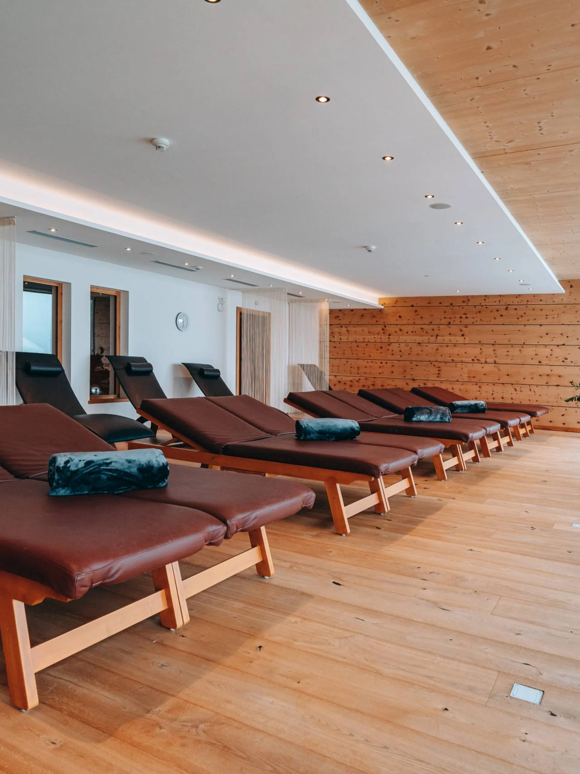 Ruheraum mit Liegen und Holzwänden in einem modernen Spa