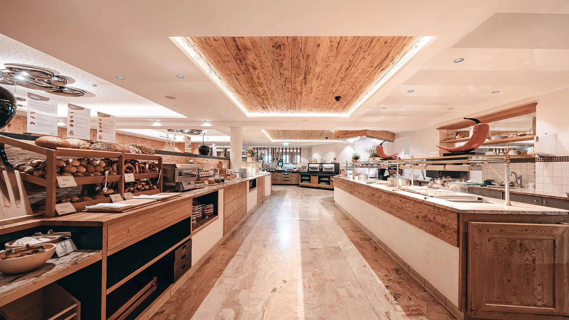 Spacious buffet with bread selection and hot dishes in a modern restaurant