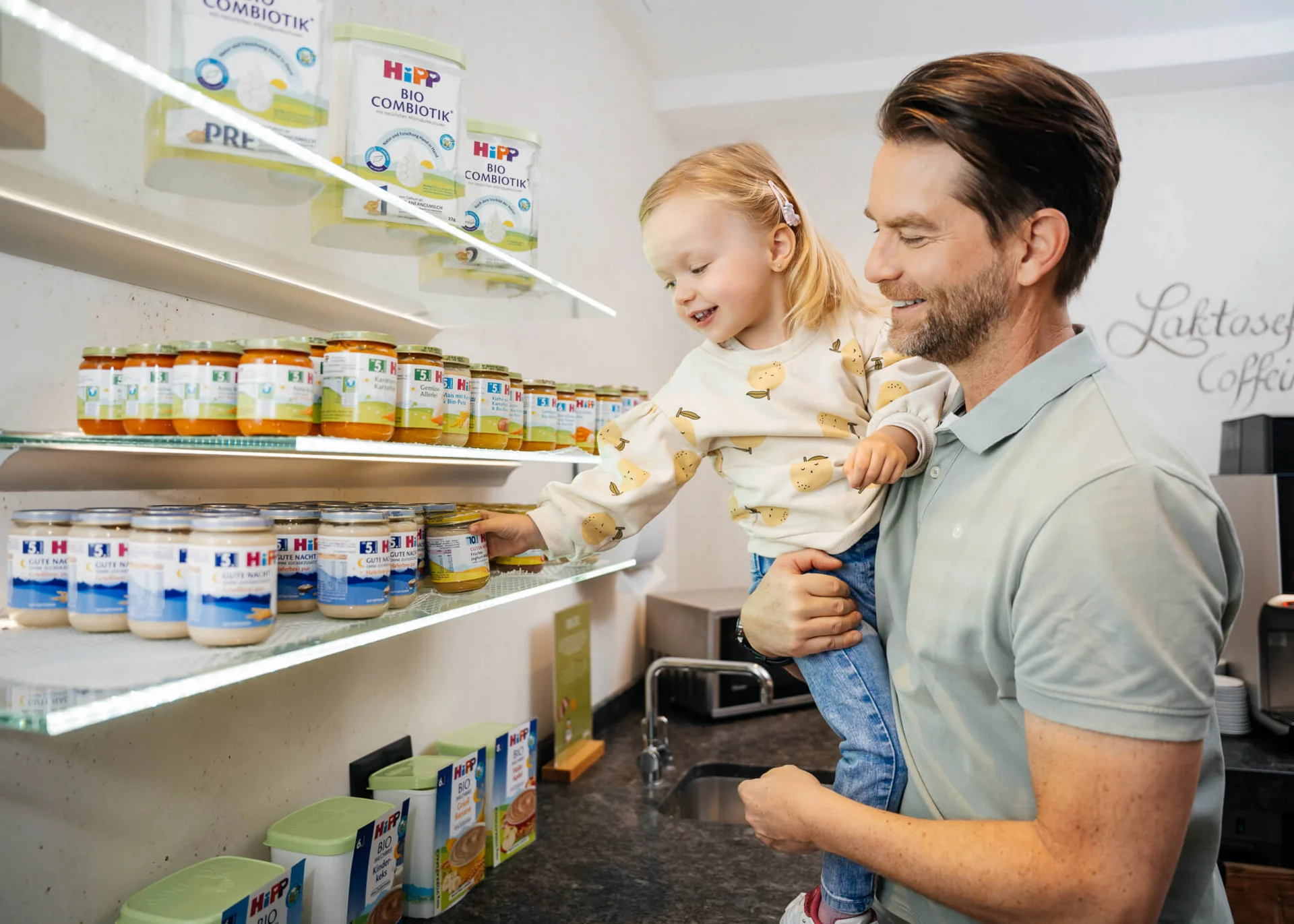 Man holding child picking baby food from shelf